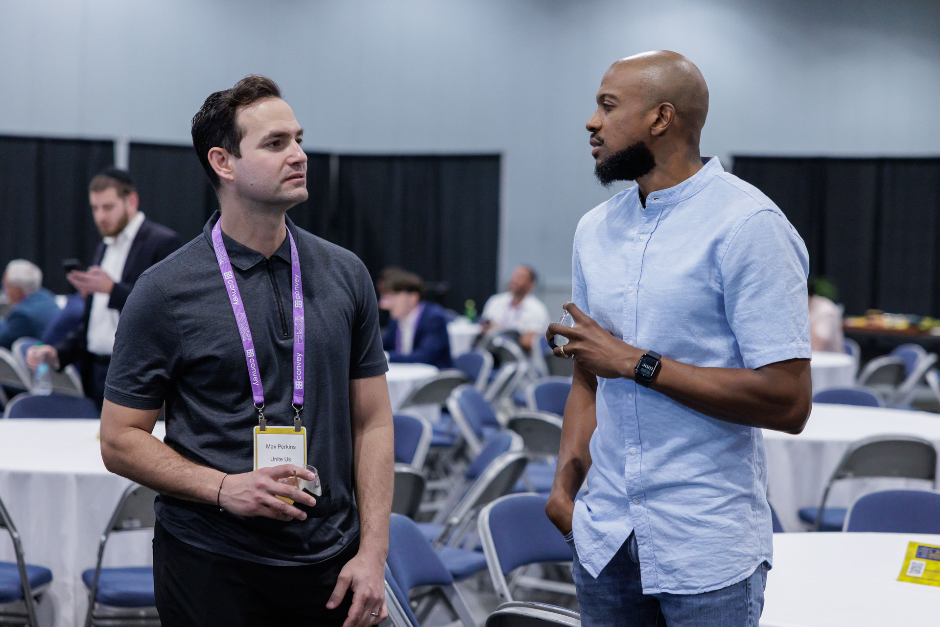 Sponsors and attendees speaking in the exhibit hall
